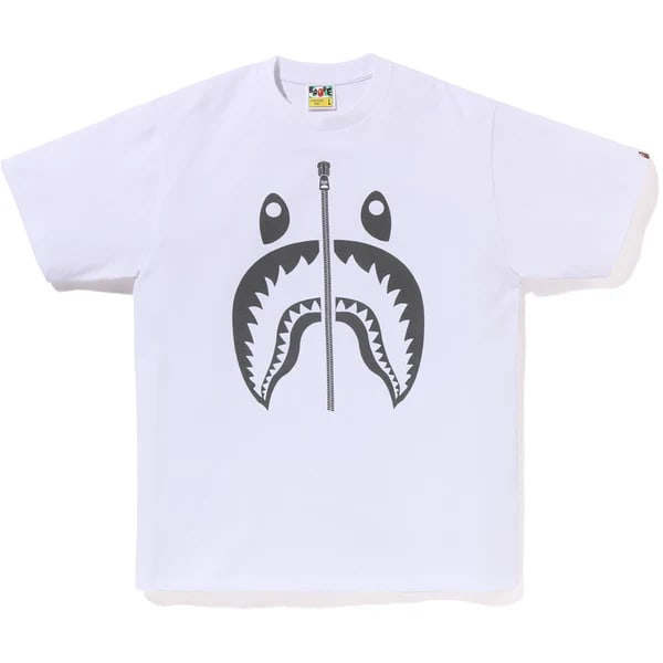 A Bathing Ape Pigment Shark cotton T shirt white Large: A Bathing Ape Pigment Shark cotton T shirt white Large White short-sleeve T-shirt featuring a pigment-printed shark graphic on the front. Made of cotton with a relaxed fit and a vintage-washed look. S