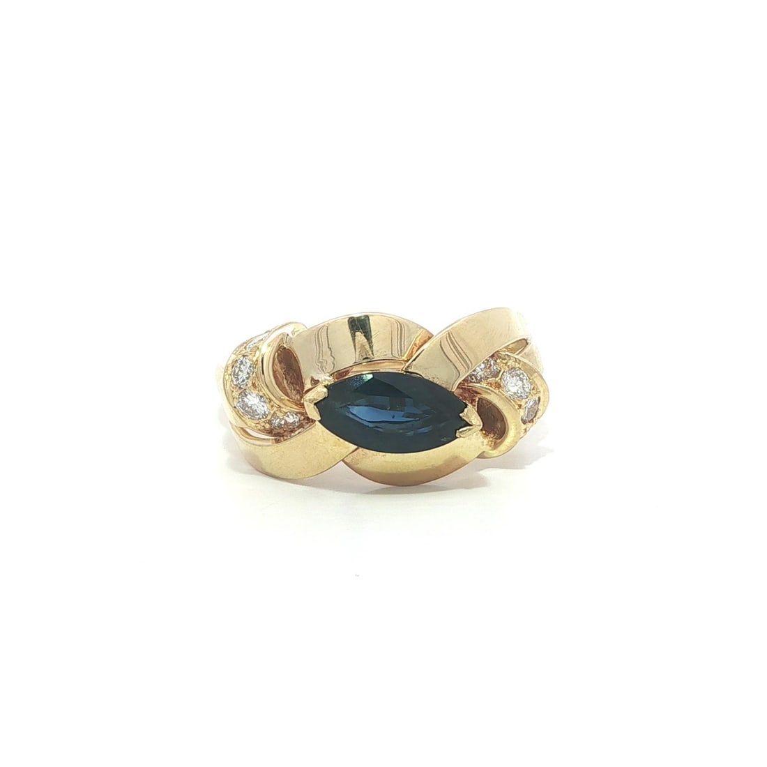 Marquise Sapphire and Diamond Braided East West 18k Yellow Gold Band Ring: Marquise Sapphire and Diamond Braided East West 18k Yellow Gold Band Ring This elegant band ring features a marquise-cut natural sapphire set in solid 18k yellow gold, accented by eight round brillian
