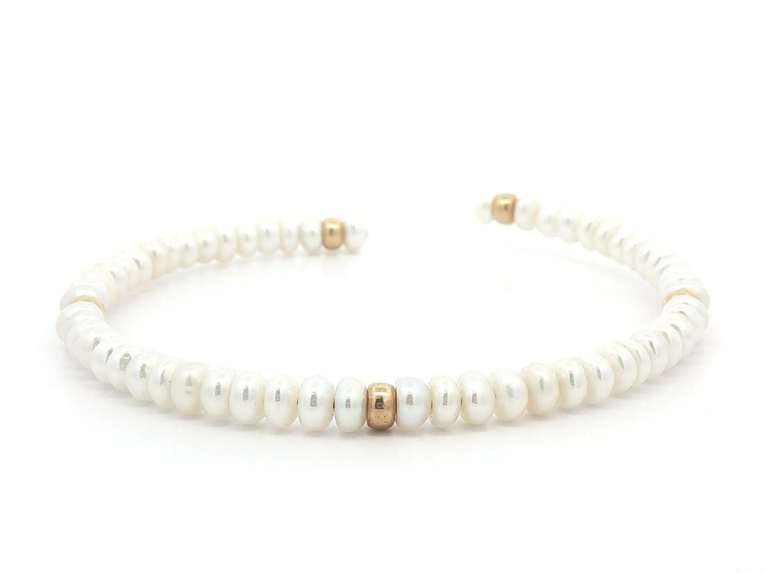 Open Cuff Pearl Bangle Bracelet in 14k Yellow Gold Beads: Open Cuff Pearl Bangle Bracelet in 14k Yellow Gold Beads Open cuff bangle bracelet featuring numerous genuine cultured round button pearls separated by solid 14k yellow gold bead spacers. This pre-own
