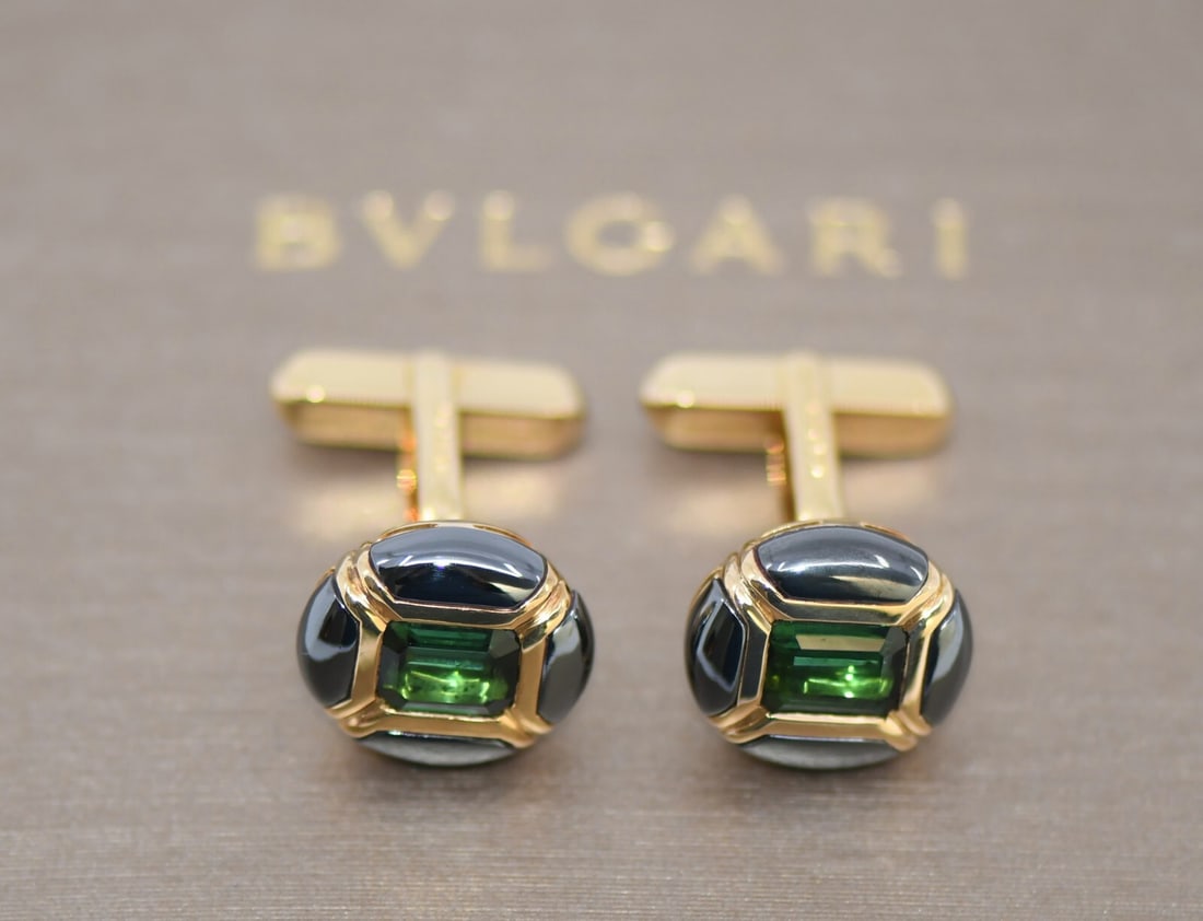 Bulgari 18K Yellow Gold Emerald Cufflinks Authentic: Bulgari 18K Yellow Gold Emerald Cufflinks Authentic Elevate your formal attire with these exquisite Bulgari cufflinks, crafted from luxurious 18K yellow gold and adorned with stunning emeralds. With a