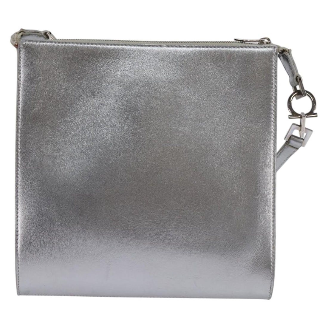 Salvatore Ferragamo Gancini Silver Leather Shoulder Bag: Salvatore Ferragamo Gancini Silver Leather Shoulder Bag This Salvatore Ferragamo Gancini shoulder bag for women features silver leather construction with a compact design. The bag shows signs of surfa