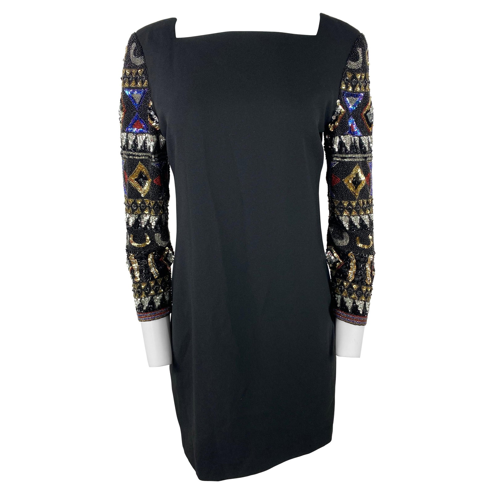 I. Magnin black mini dress with rhinestone long sleeves: I. Magnin black mini dress with rhinestone long sleeves Black mini evening dress by I. Magnin featuring long sleeves with a multicolored rhinestone design and a rear zip closure. Condition is excellen