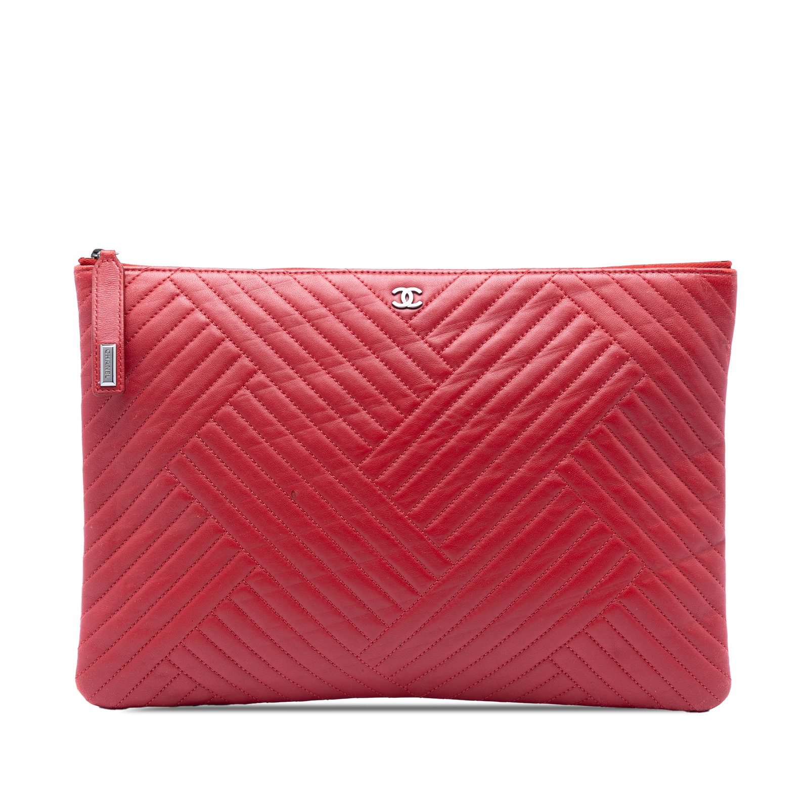 Chanel O Case Clutch in Red Quilted Lambskin Leather: Chanel O Case Clutch in Red Quilted Lambskin Leather Large Chanel O Case clutch crafted in red diagonal quilted lambskin leather with a top zip closure. Made in Italy, this piece shows visible wear co