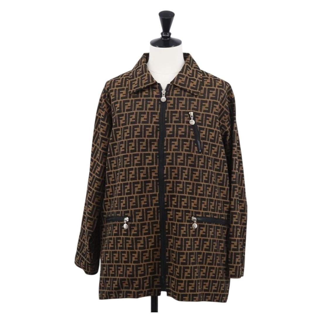 Reversible Brown Black Zucca Canvas Jacket by FENDI: Reversible Brown Black Zucca Canvas Jacket by FENDI This FENDI Zucca Canvas reversible jacket features a stylish brown and black color scheme. Crafted from canvas with the iconic Zucca pattern, the ja