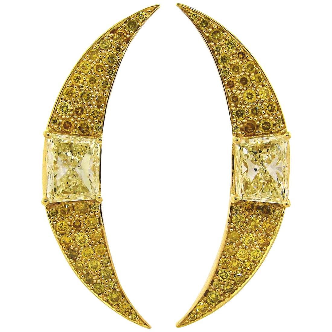 18k Yellow Gold Diamond Crescent Earrings Pair Fancy Yellow Stones: 18k Yellow Gold Diamond Crescent Earrings Pair Fancy Yellow Stones A pair of crescent earrings set with yellow diamonds in mixed cuts. Designed in yellow gold, these earrings feature two trapezoid-sha