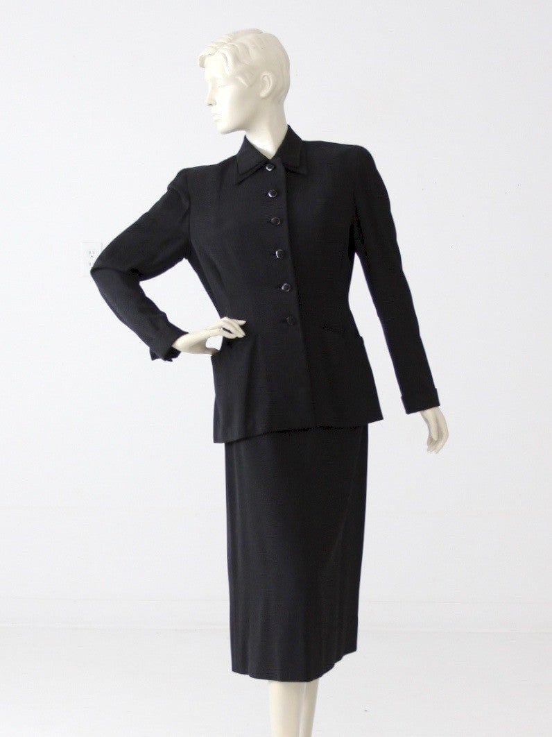 1950s Bucci Vintage Figurette Black Skirt Suit Ensemble: 1950s Bucci Vintage Figurette Black Skirt Suit Ensemble Step back in time with this exquisite 1950s vintage Figurette by Bucci women's skirt suit. This hand-tailored black ensemble includes a stylish 
