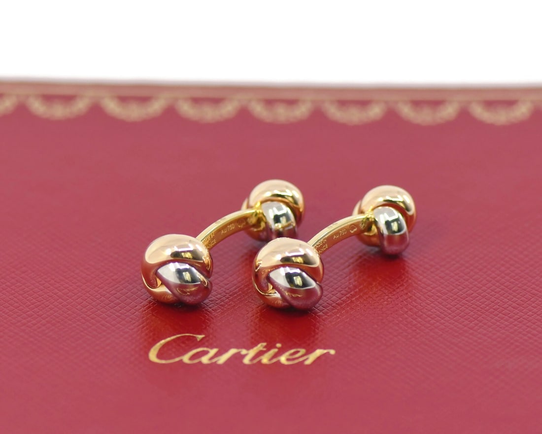 Cartier Trinity 18K Tri-Color Gold Cufflinks Authentic 29mm: Cartier Trinity 18K Tri-Color Gold Cufflinks Authentic 29mm Elevate your accessory collection with these exquisite Cartier Trinity cufflinks, crafted from 18K tri-color gold. These cufflinks feature a