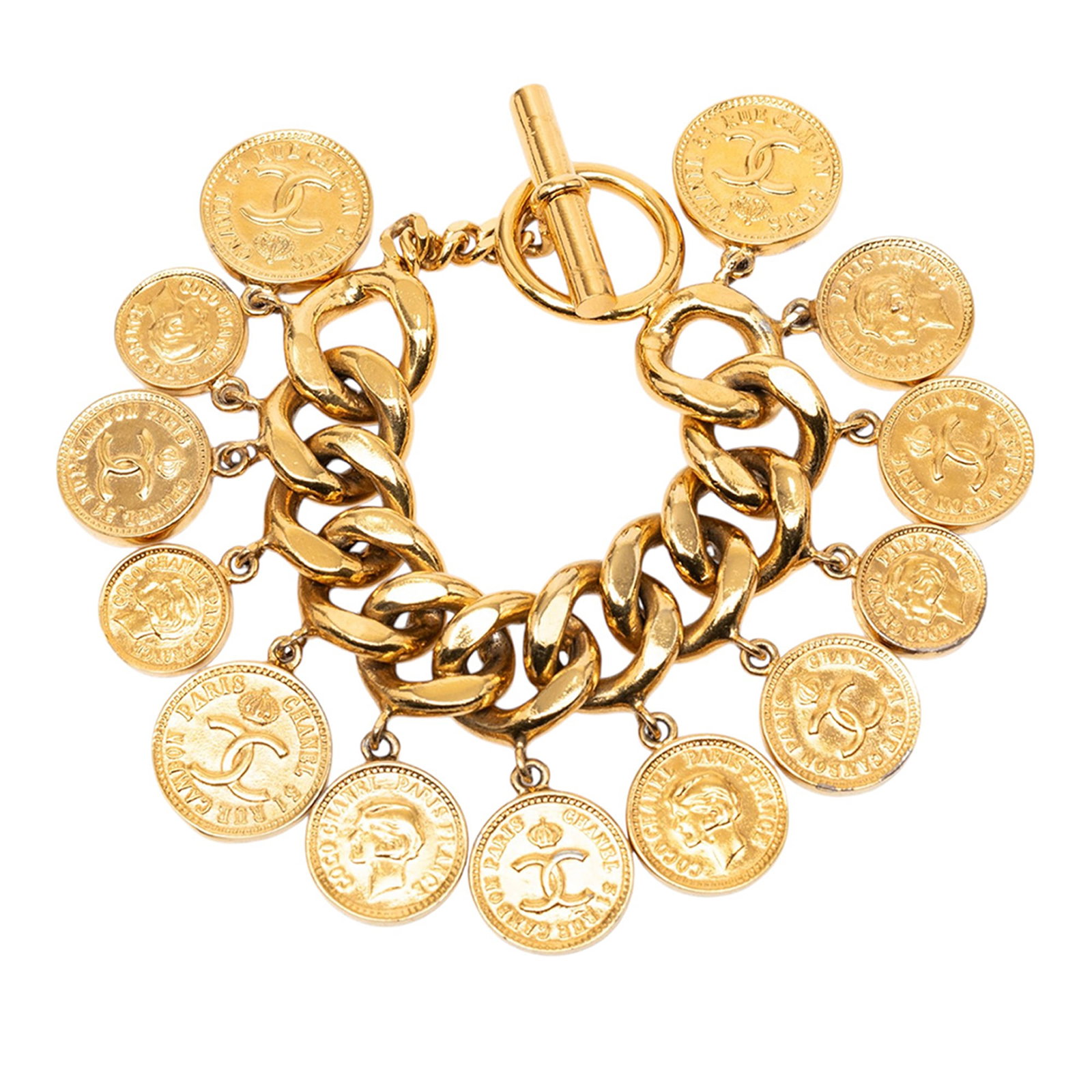 Chanel CC coin charm bracelet in gold plated metal: Chanel CC coin charm bracelet in gold plated metal Chanel CC coins charm bracelet in gold-plated metal with a toggle clasp closure. This costume jewelry piece is made in France and shows wear consiste