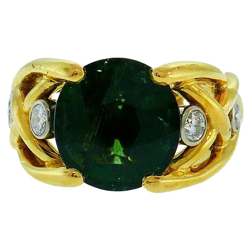 French BJ Signed 18k Yellow Gold Tourmaline Diamond Ring: French BJ Signed 18k Yellow Gold Tourmaline Diamond Ring Vintage ring featuring a round faceted green tourmaline set in 18k yellow gold and accented with round brilliant cut diamonds. The diamonds are