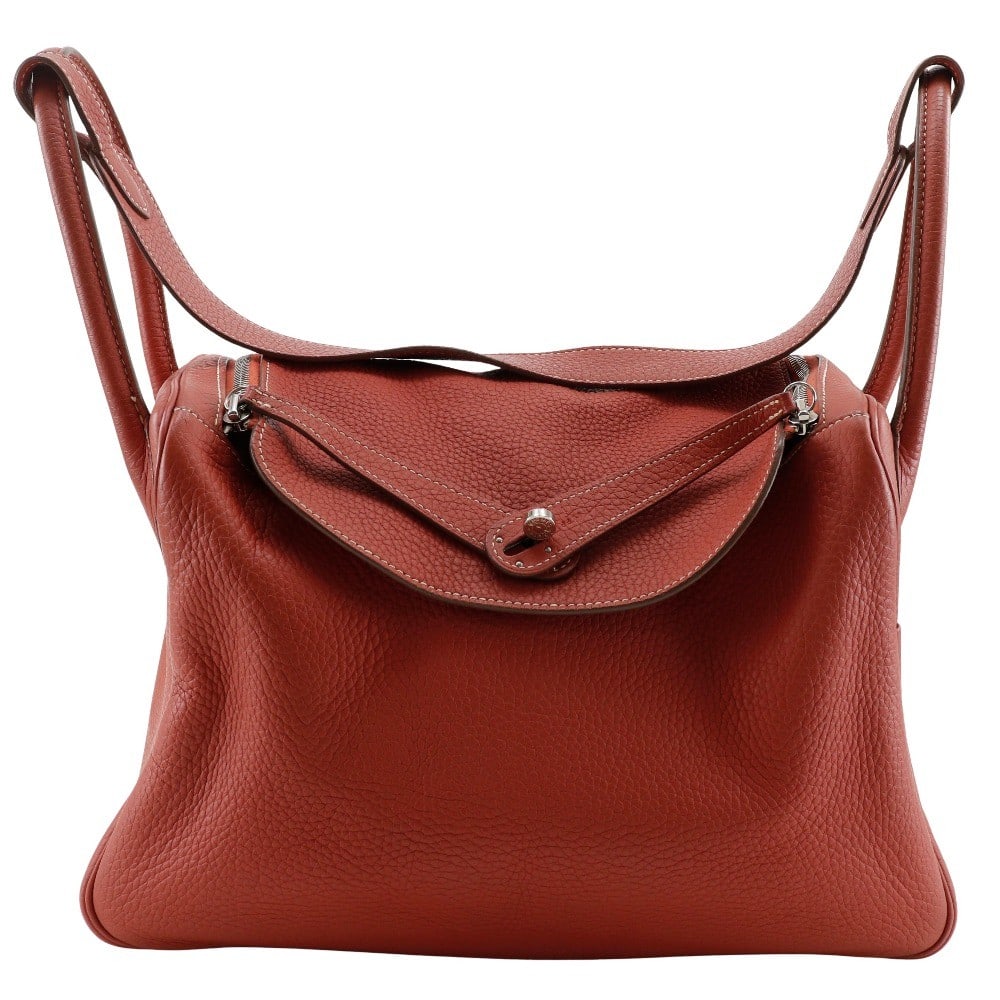 Hermes Lindy orange Togo leather handbag 33cm: Hermes Lindy orange Togo leather handbag 33cm The Hermes Lindy Bag in vibrant orange is crafted from durable Togo leather, designed for women. This handbag features a spacious interior with pockets, s
