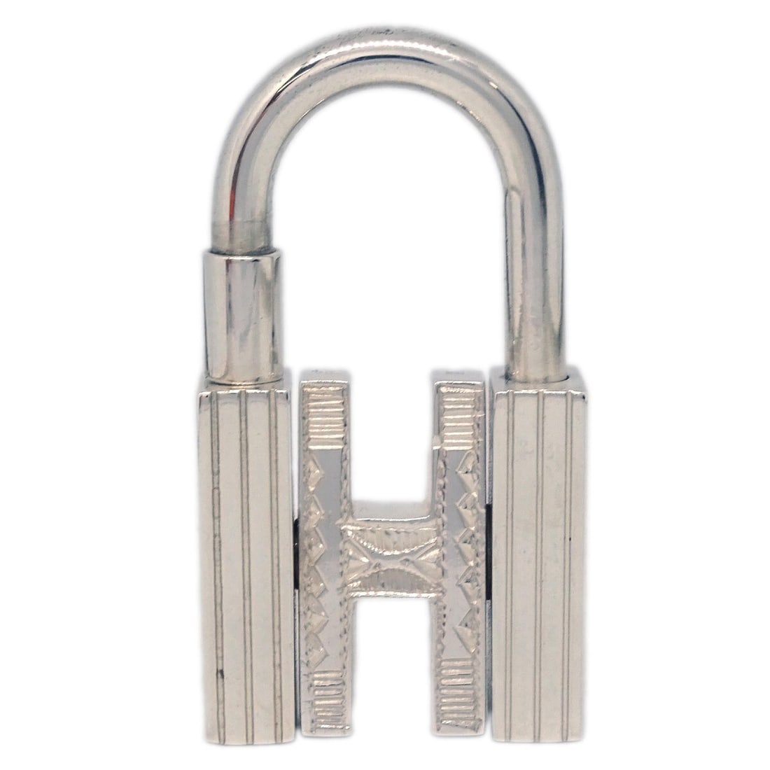 HERMES Touareg H Cadena Sterling Silver Padlock Charm Small: HERMES Touareg H Cadena Sterling Silver Padlock Charm Small Hermes Touareg H Cadena in sterling silver. This small padlock-style accessory features a decorative design with the signature H motif and i