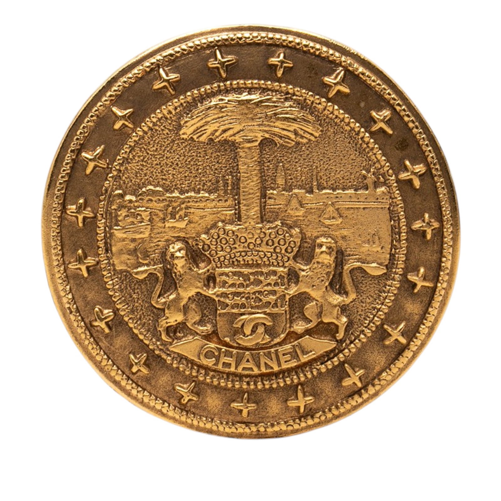 Chanel Lion Crest Medallion CC Gold Plated Brooch: Chanel Lion Crest Medallion CC Gold Plated Brooch Gold plated metal brooch with a lion crest medallion design and back pin closure. Made in France and classified as costume jewelry. The exterior back,