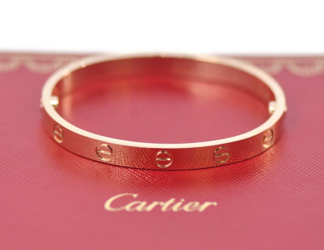 Cartier 18K Rose Gold Love Bangle Bracelet Size 16 with Authenticity: Cartier 18K Rose Gold Love Bangle Bracelet Size 16 with Authenticity Introducing the exquisite Cartier 18K Rose Gold Love Bracelet, a timeless symbol of love and elegance. Crafted from 18k rose gold, 