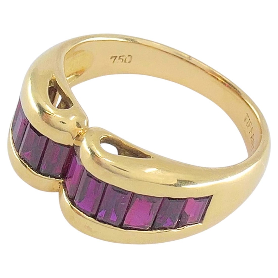 Tiffany & Co. Ruby Baguette 18k Gold Band Ring Size 5.5: Tiffany & Co. Ruby Baguette 18k Gold Band Ring Size 5.5 Vintage Tiffany & Co. ring from the 1980s, crafted in 18k gold and set with a continuous row of baguette-cut rubies in a curved band design. The