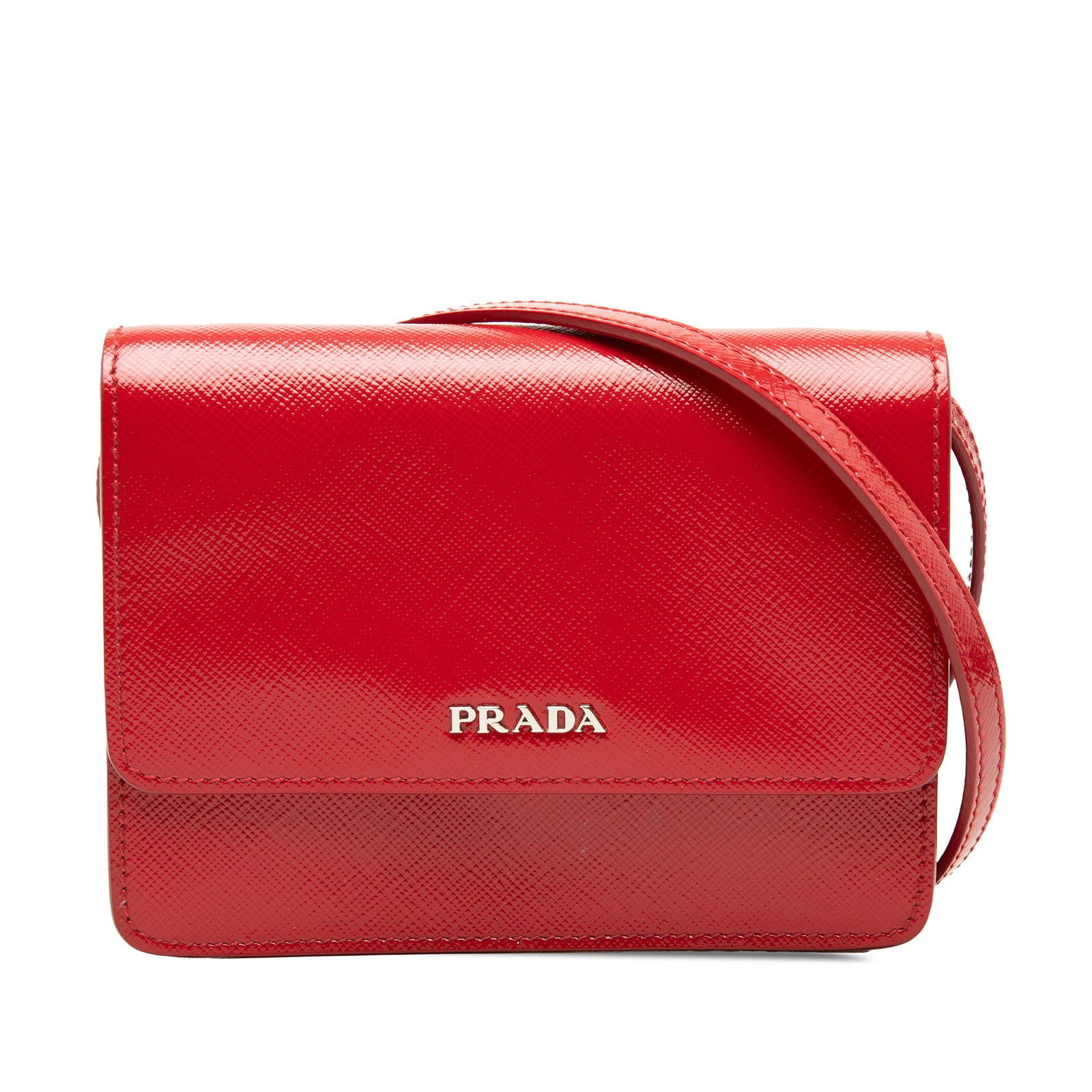 Prada Saffiano Vernice leather crossbody bag red: Prada Saffiano Vernice leather crossbody bag red Prada Saffiano Vernice crossbody bag in red leather with an adjustable flat shoulder strap and front flap with magnetic snap closure. The interior incl