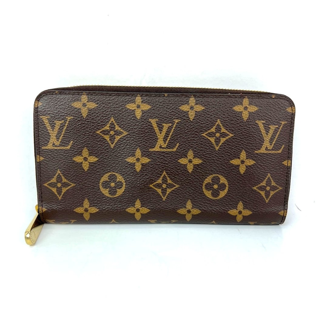 Louis Vuitton Monogram Zip Around Leather Wallet Fuchsia: Louis Vuitton Monogram Zip Around Leather Wallet Fuchsia This Louis Vuitton Zippy wallet features the iconic Monogram pattern on durable leather canvas in a classic brown color, accented with the sign