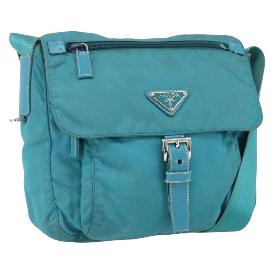 PRADA Nylon Shoulder Bag in Turquoise Blue with Silver Tone: PRADA Nylon Shoulder Bag in Turquoise Blue with Silver Tone Prada shoulder bag in nylon with a turquoise blue and silver colorway. Made in Italy, this women's bag measures approximately 23 cm wide, 22