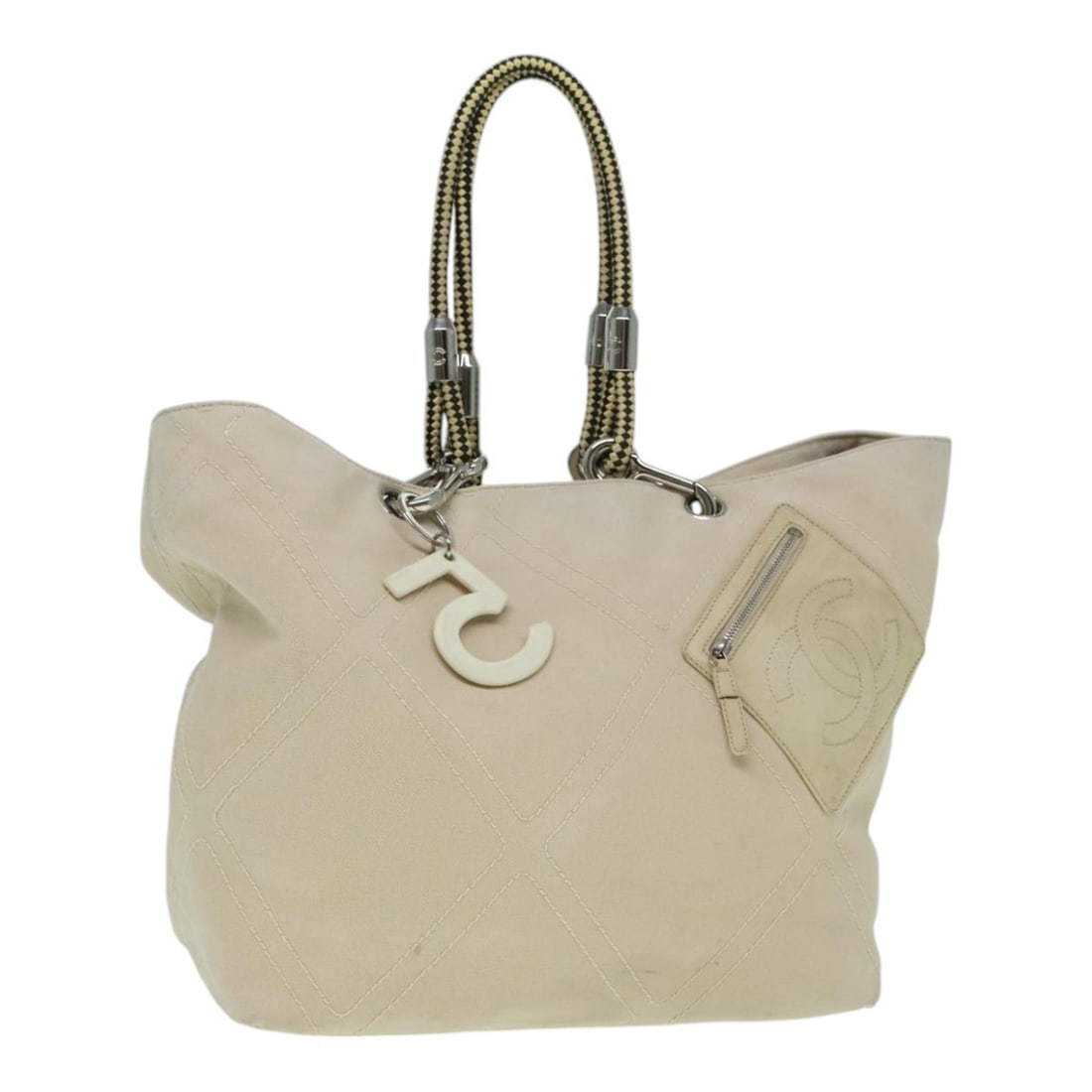 CHANEL Coco Mark Canvas Tote Beige Silver Charm: CHANEL Coco Mark Canvas Tote Beige Silver Charm A CHANEL Coco Mark tote bag in beige and silver canvas, made in Italy. It features a tote bag style with a charm accessory and is designed for women. Th