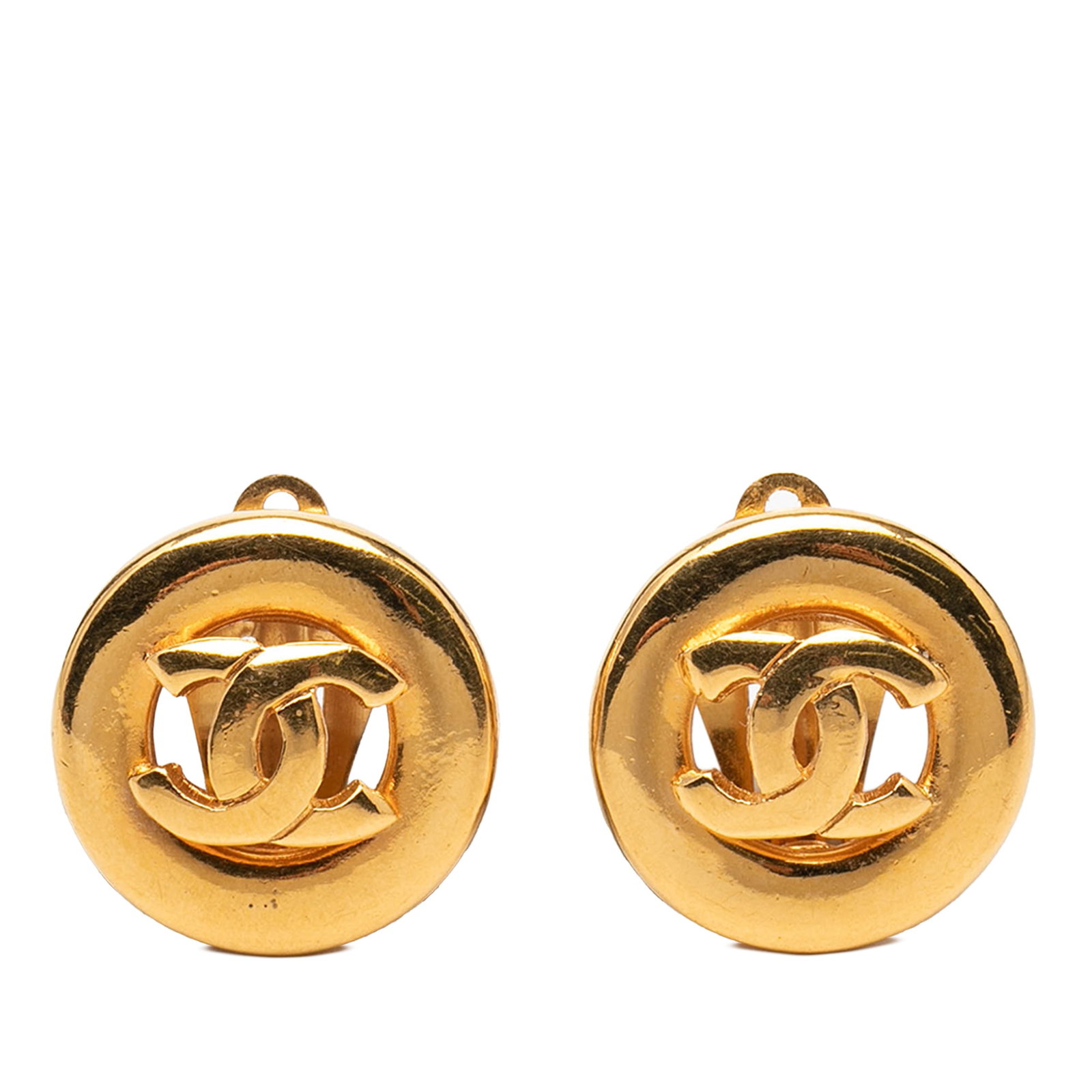 Chanel CC Logo Metal Gold Plated Clip On Round Earrings: Chanel CC Logo Metal Gold Plated Clip On Round Earrings These Chanel earrings feature a round design with gold plated metal bodies and clip-on closures. The earrings display classic style elements and