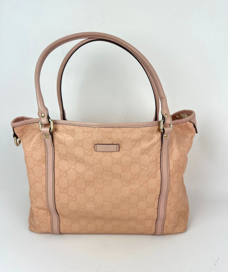 Guccissima Joy Medium Pink Leather Tote by Gucci: Guccissima Joy Medium Pink Leather Tote by Gucci This Gucci Guccissima Joy Medium Tote Bag features pink leather with the distinctive Guccissima pattern and a matte finish. Designed in a trapezoid sha