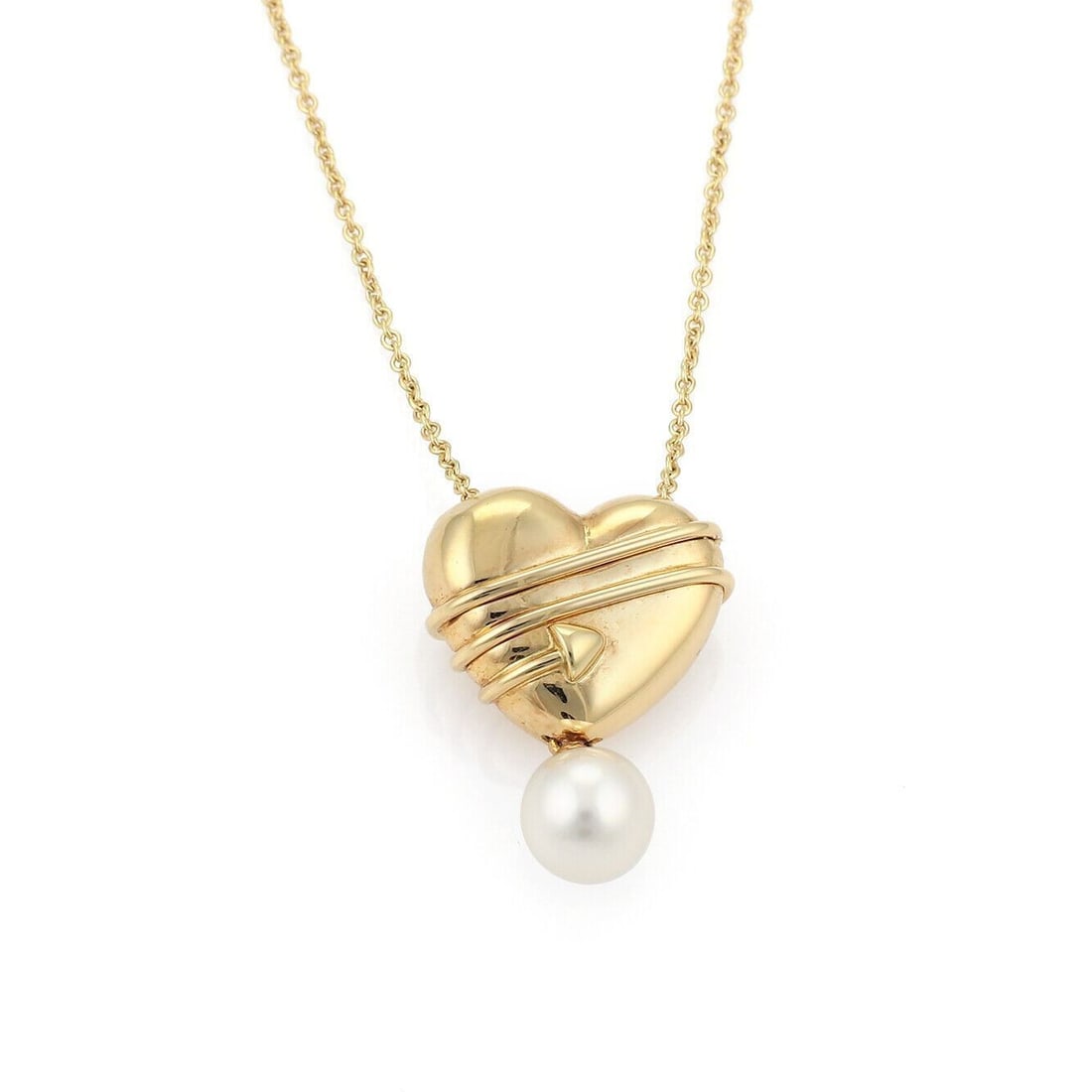 Tiffany & Co. 18k Yellow Gold Heart Pendant Necklace with Pearl and Cupid Arrow: Tiffany & Co. 18k Yellow Gold Heart Pendant Necklace with Pearl and Cupid Arrow Vintage Tiffany & Co. pendant necklace in 18k yellow gold, featuring a sculptural heart pierced by Cupid's arrow and acc