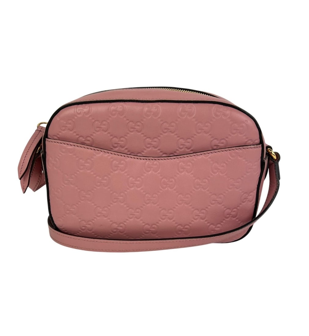 Pink Gucci Guccissima leather camera crossbody bag: Pink Gucci Guccissima leather camera crossbody bag This Gucci Guccissima Camera crossbody bag features a semi-circle silhouette crafted from pink leather with a signature logo pattern and matelasse fi