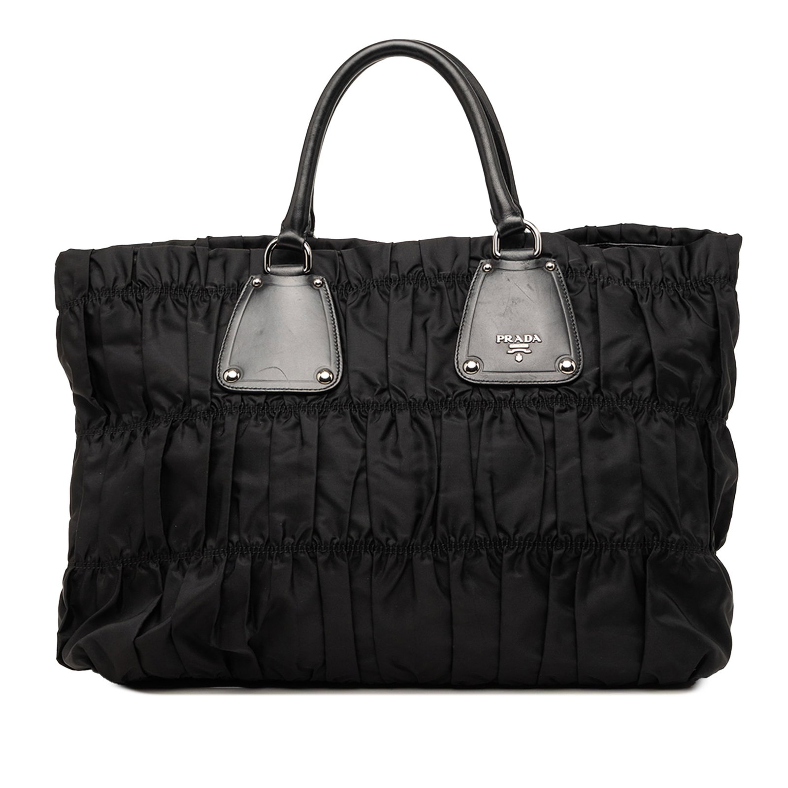 Prada Tessuto Gaufre Black Nylon Tote Bag: Prada Tessuto Gaufre Black Nylon Tote Bag Prada Tessuto Gaufre tote bag with a gathered nylon body, rolled leather handles, an open top with magnetic snap closure, and an interior zip pocket. Conditio