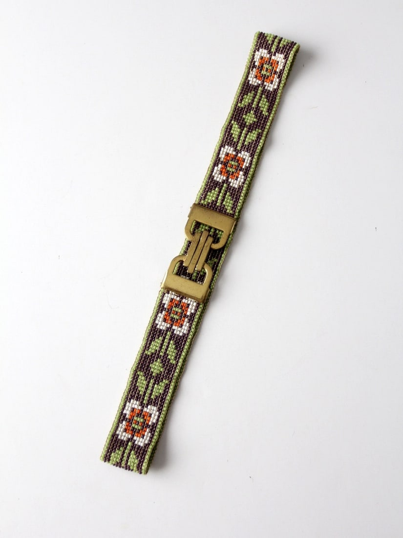1920s Vintage Hand-Beaded Floral Belt with Art Deco Buckle: 1920s Vintage Hand-Beaded Floral Belt with Art Deco Buckle Discover a stunning hand-beaded belt from the 1920s, featuring a charming floral pattern in green, white, and pink. This vintage accessory is