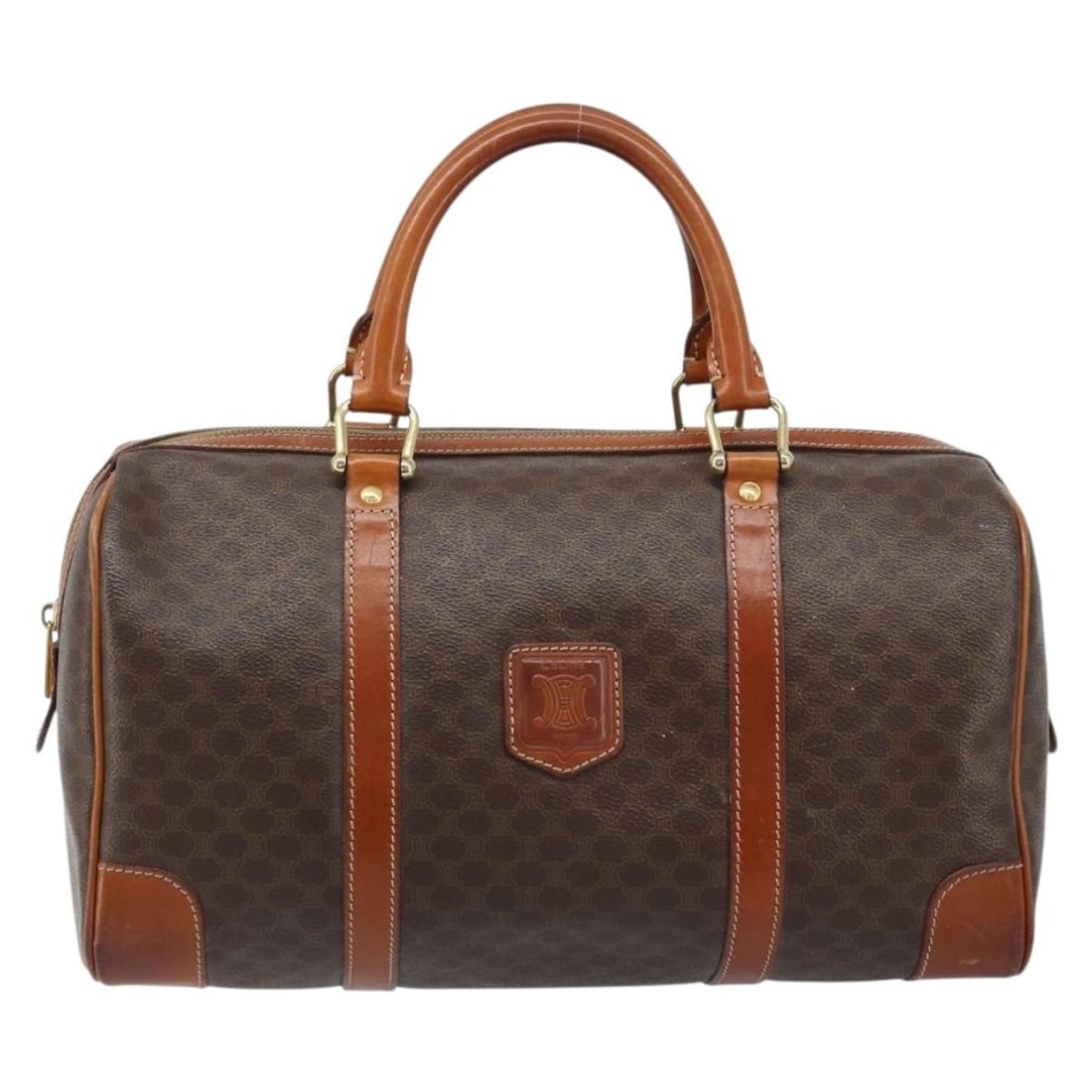 Celine Brown Canvas Vintage Duffle Bag with Leather Trim: Celine Brown Canvas Vintage Duffle Bag with Leather Trim This Celine vintage duffle bag features a classic brown canvas exterior with leather accents, designed for women. The bag shows signs of wear c