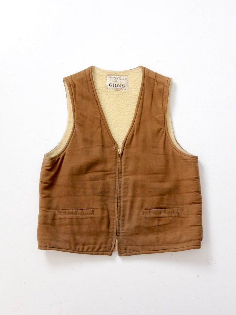 1970s Vintage Grais Brown Cotton Vest with Sherpa Lining: 1970s Vintage Grais Brown Cotton Vest with Sherpa Lining This vintage Grais outerwear vest, dating back to the 1970s, showcases a classic brown cotton exterior complemented by a cozy sherpa-style flee