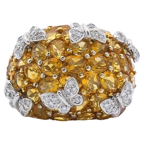 Butterfly Dome Ring in 14k White Gold with Citrine and Diamonds: Butterfly Dome Ring in 14k White Gold with Citrine and Diamonds This 1980s dome-style cocktail ring is crafted in 14k white gold and features a butterfly motif accented with diamonds over a surface se