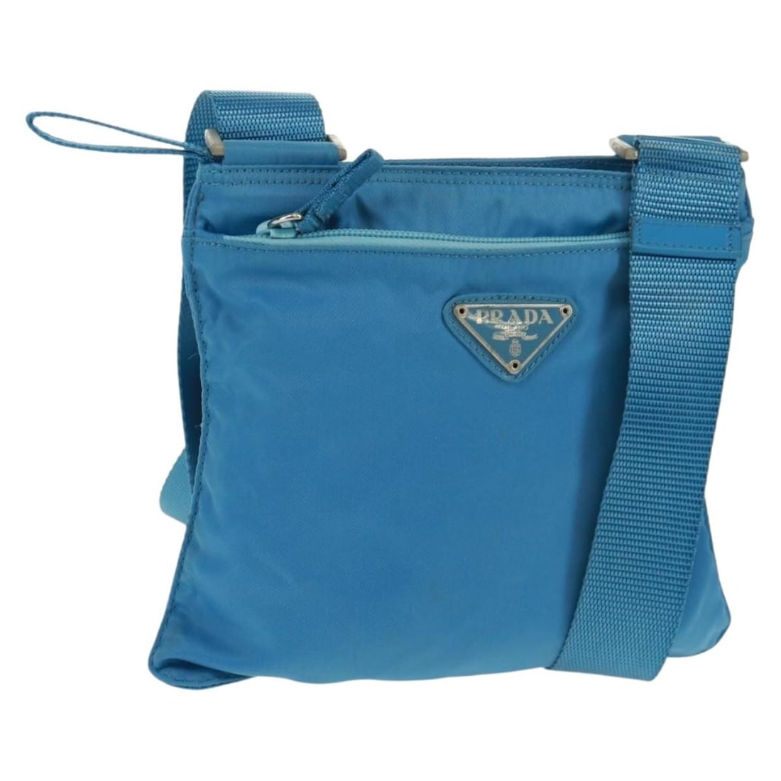 Prada Blue Silver Nylon Shoulder Bag with Dust Bag: Prada Blue Silver Nylon Shoulder Bag with Dust Bag Authentic Prada shoulder bag in blue nylon with silver-tone accents. This women's bag includes a dust bag and is made in Italy. Condition is rated B 