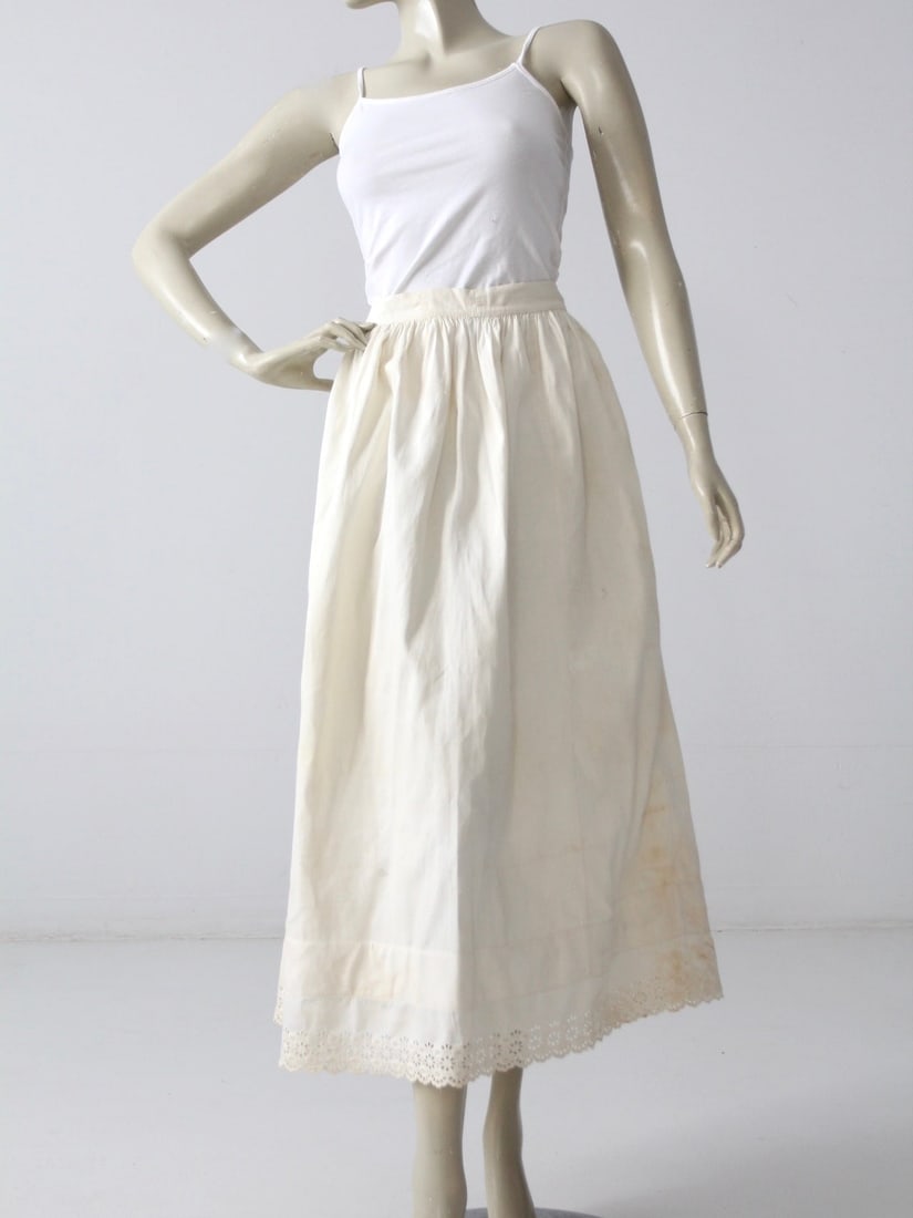Vintage Cream Cotton Antique Petticoat Skirt with Eyelet Lace Hem: Vintage Cream Cotton Antique Petticoat Skirt with Eyelet Lace Hem Discover timeless elegance with this Antique Petticoat Skirt from our Stylist's Collection. Crafted from soft cream cotton, this skirt