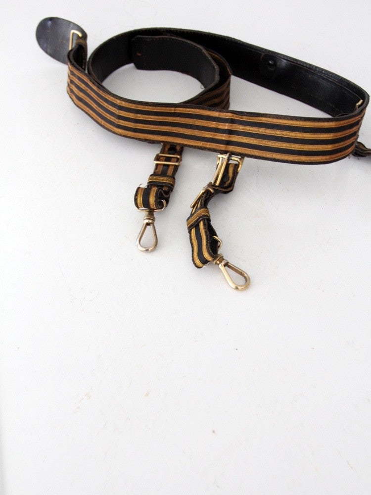 1920s Vintage C.E. Ward Lodge Regalia Belt Black Gold Stripes: 1920s Vintage C.E. Ward Lodge Regalia Belt Black Gold Stripes This vintage lodge regalia belt, crafted by C.E. Ward Co. of Ohio, dates back to the 1920s. Made from aged leather and textile, it feature