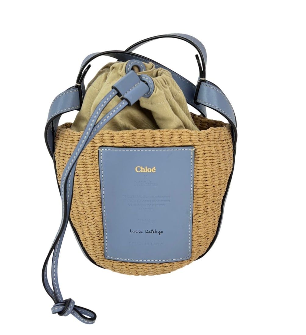 Chloe X Mafuko Small Blue Raffia Leather Shoulder Bag: Chloe X Mafuko Small Blue Raffia Leather Shoulder Bag Chloe X Mifuko shoulder bag in a small semi-circle basket style, made with canvas, raffia, and leather. It features a drawstring closure, blue lea