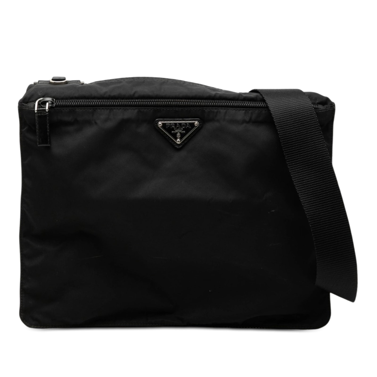 Prada Tessuto Black Nylon Crossbody Bag with Zip Closure: Prada Tessuto Black Nylon Crossbody Bag with Zip Closure Prada Tessuto Zip Top Crossbody in black fabric with a zip-top closure, adjustable flat canvas shoulder strap, exterior front zip pocket, and i