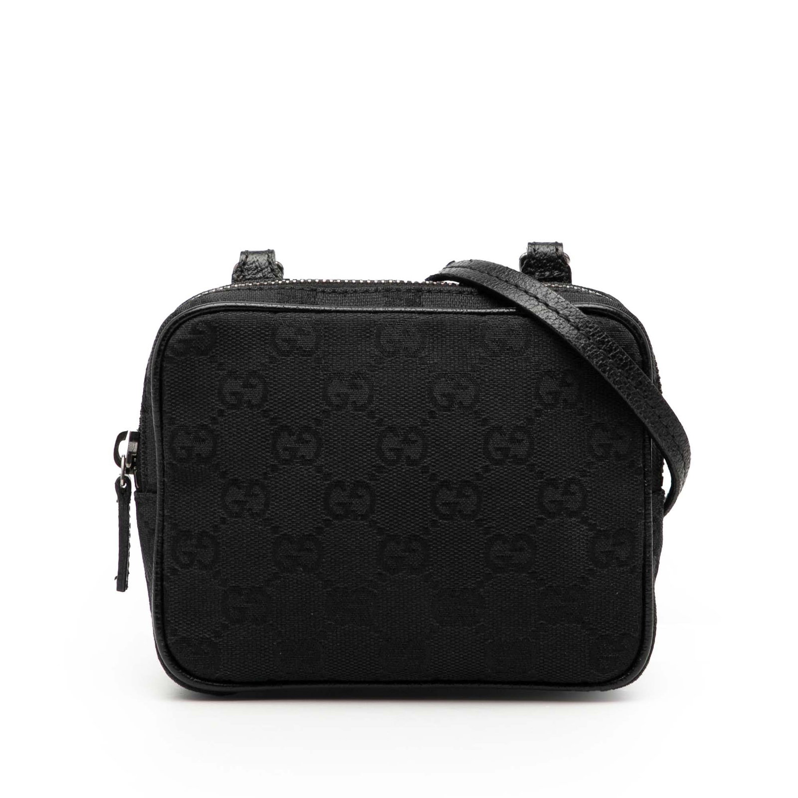 Black GG Canvas Crossbody Bag with Leather Trim by Gucci: Black GG Canvas Crossbody Bag with Leather Trim by Gucci This Gucci GG Canvas Crossbody bag features a black canvas body with leather trim, a flat strap, and a top zip closure. The bag shows signs of 