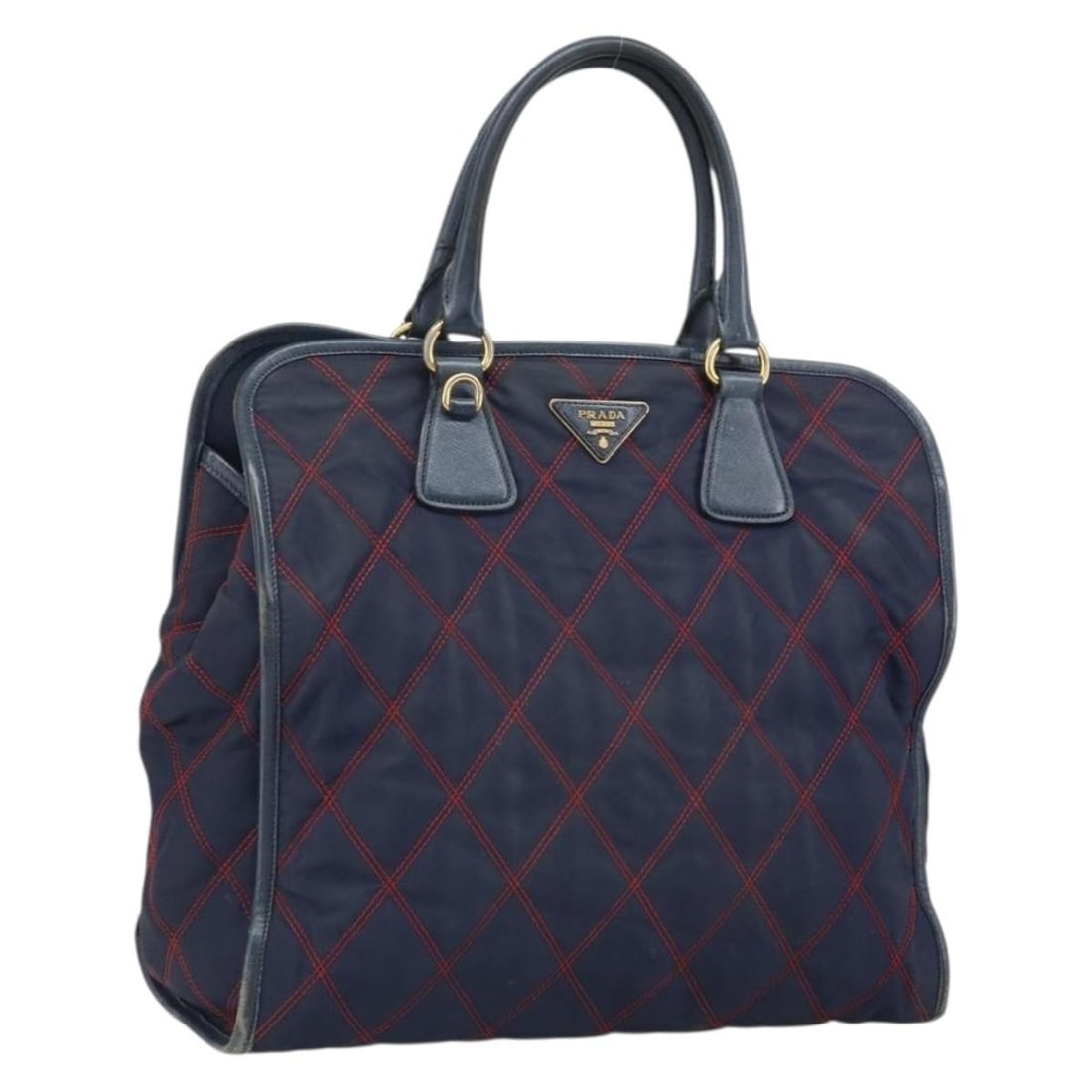 Prada Navy Nylon Handbag with Gold Tone Hardware: Prada Navy Nylon Handbag with Gold Tone Hardware Prada women's nylon handbag in navy with gold-tone accents, made in Romania. This heavily used bag shows visible wear throughout, including loss of sha