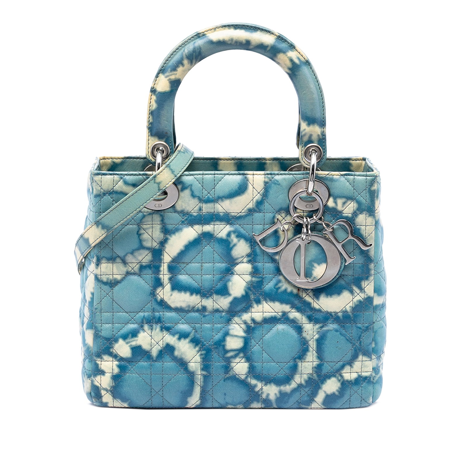 Dior Lady Dior Medium Blue Tie Dye Calfskin Handbag: Dior Lady Dior Medium Blue Tie Dye Calfskin Handbag A Medium Lady Dior bag crafted in calfskin with a tie-dye print. This Italian-made handbag features flat leather top handles, a detachable flat leat
