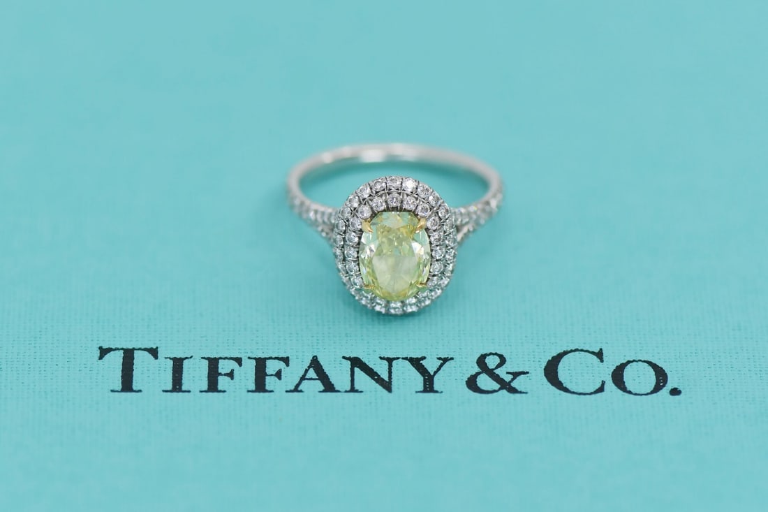 Tiffany Platinum Ring with 1.54ct Fancy Intense Yellow Diamond Size 5: Tiffany Platinum Ring with 1.54ct Fancy Intense Yellow Diamond Size 5 This platinum ring from Tiffany & Co. features a 1.54 carat oval fancy intense yellow diamond at the center, graded VVS2 for clari