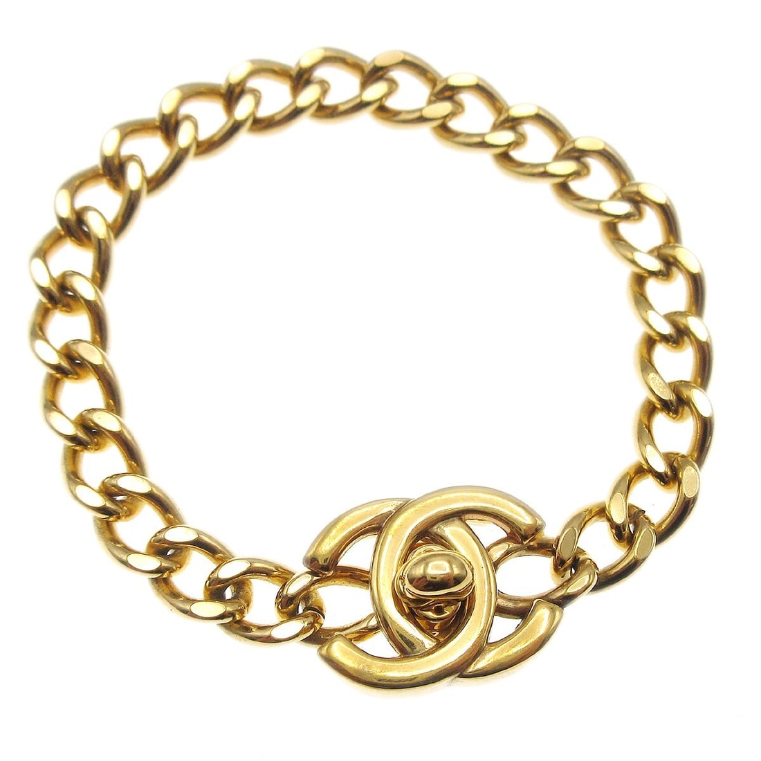 Gold Plated Chain Bracelet Chanel Turnlock Motif 7.5 in: Gold Plated Chain Bracelet Chanel Turnlock Motif 7.5 in Gold-plated chain bracelet with a turnlock motif charm and logo clasp. The bracelet is in fair condition with reasonable wear and tear. Made in 