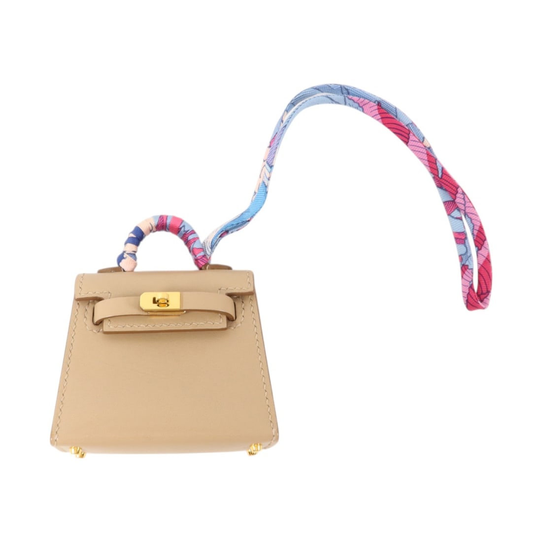 Hermes Kelly Twilly bag charm in Argile Tadelakt calfskin: Hermes Kelly Twilly bag charm in Argile Tadelakt calfskin Hermes Kelly Twilly bag charm in Argile Tadelakt leather. This women's charm is crafted in calfskin and comes with its storage box and storage