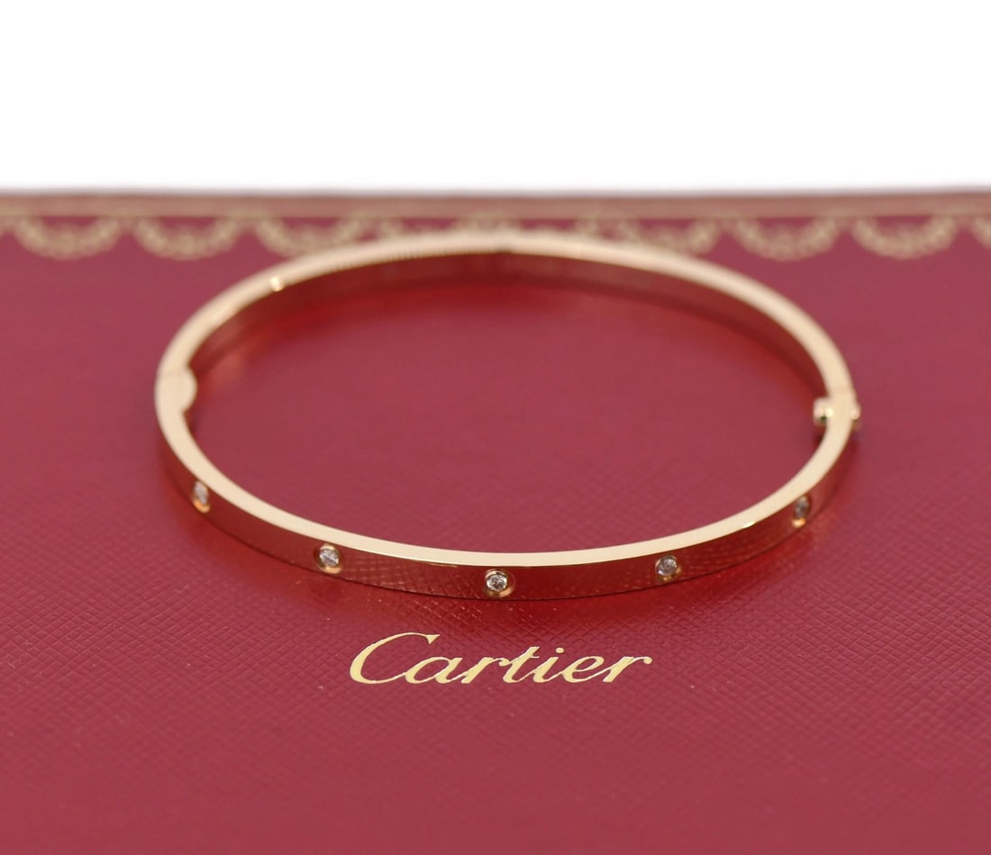 Cartier 10 Diamond 18K Rose Gold Love Bracelet Small Model: Cartier 10 Diamond 18K Rose Gold Love Bracelet Small Model Embodying elegance and romance, this Cartier Love Bracelet features 10 shimmering diamonds set in exquisite 18K rose gold. The bracelet is a 