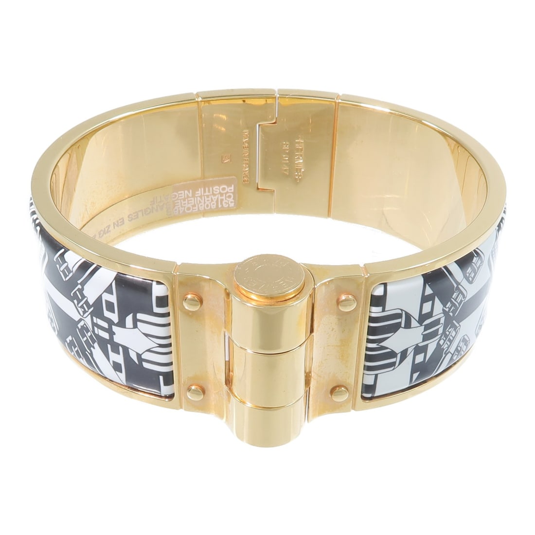 Hermes Charniere wide enamel bangle bracelet black white gold tone: Hermes Charniere wide enamel bangle bracelet black white gold tone Hermes GHW Charniere Wide Bangle Bracelet in gold with black and white enamel. The bracelet is sized SP and comes with a storage box 