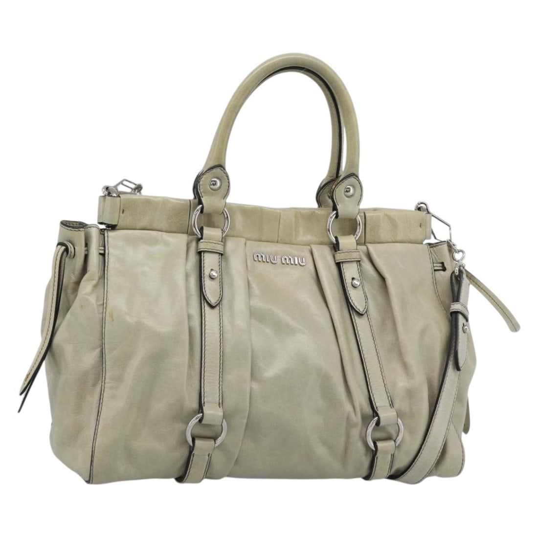 Miu Miu Beige Leather 2way Handbag with Strap and Dust Bag: Miu Miu Beige Leather 2way Handbag with Strap and Dust Bag Miu Miu 2-way handbag in beige leather with silver-tone accents. Designed for women, this bag includes both top handles and a detachable shou