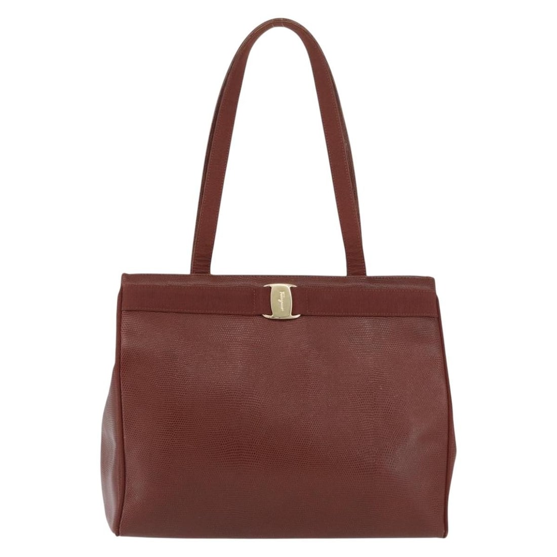 Brown Embossed Leather Vala Tote by Salvatore Ferragamo: Brown Embossed Leather Vala Tote by Salvatore Ferragamo This Salvatore Ferragamo Vala tote features embossed brown leather and is designed for women. The bag showcases a spacious interior and classic 
