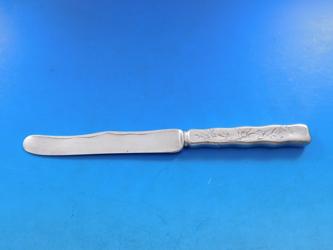 Tiffany & Co Lap Over Edge Sterling Silver Dessert Knife 7.5": Tiffany & Co Lap Over Edge Sterling Silver Dessert Knife 7.5" This exquisite dessert knife, crafted by Tiffany & Co., features the elegant Lap Over Edge design with intricate acid etching. The knife i