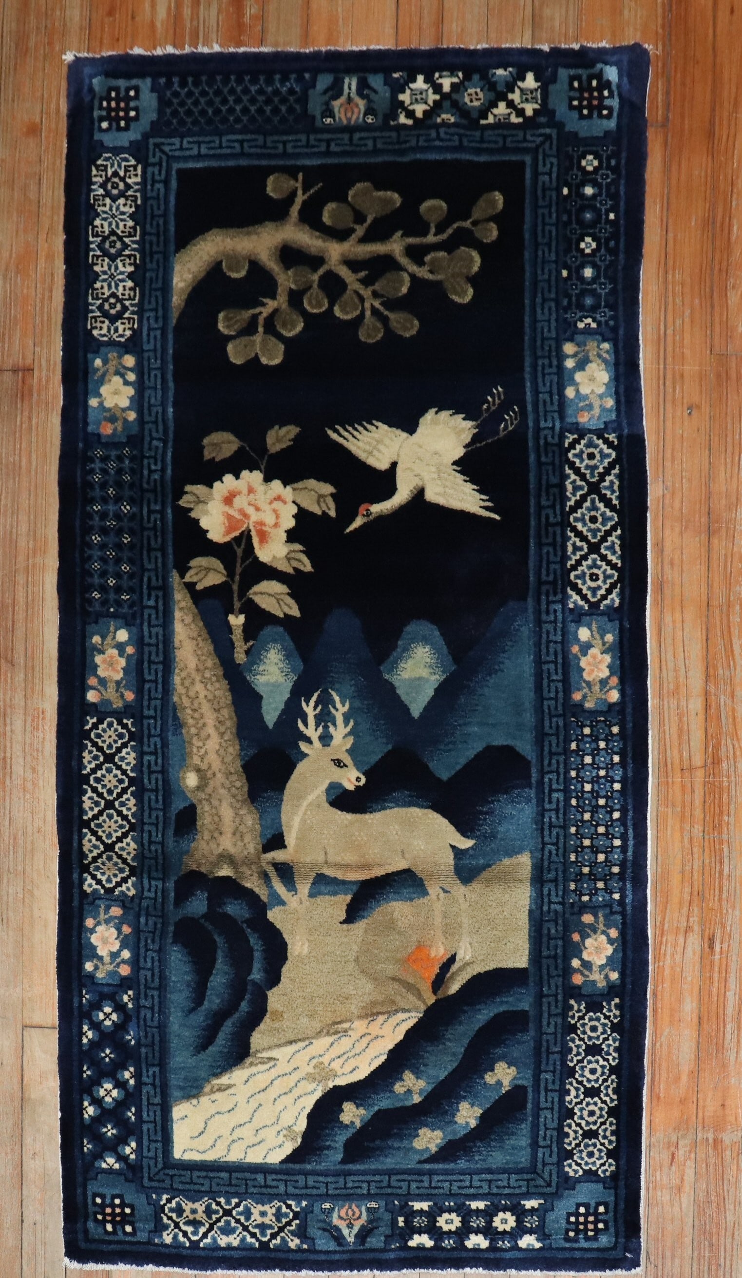 2' 6" x 4' 11" Chinese Peking Pictorial Batou Rug: 2' 6" x 4' 11" Chinese Peking Pictorial Batou Rug Early 20th century Chinese Batou pictorial rug with an animal and landscape design. The imagery includes a crane, deer, and flowering tree on a dark b