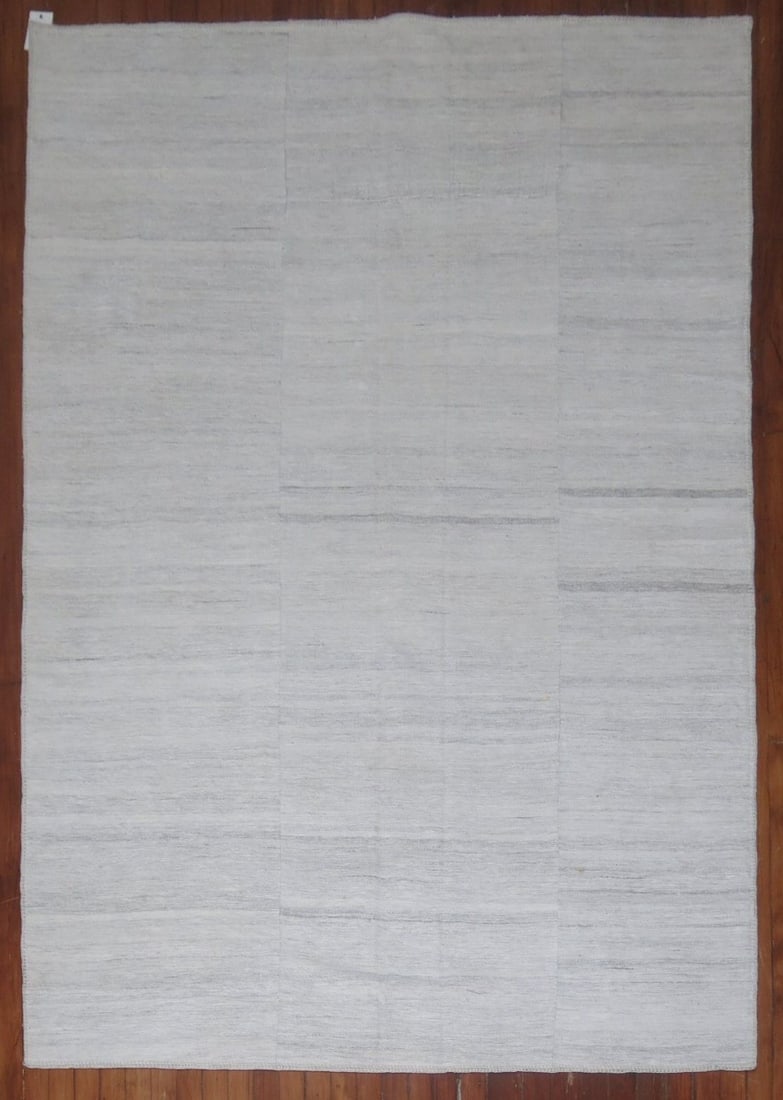 5' 5" x 8' 3" Modern Kilim Flatweave Rug: 5' 5" x 8' 3" Modern Kilim Flatweave Rug Modern flatweave kilim rug from the 21st century in a light white tone with a textured woven pattern. This pre-owned piece offers a clean, understated look con