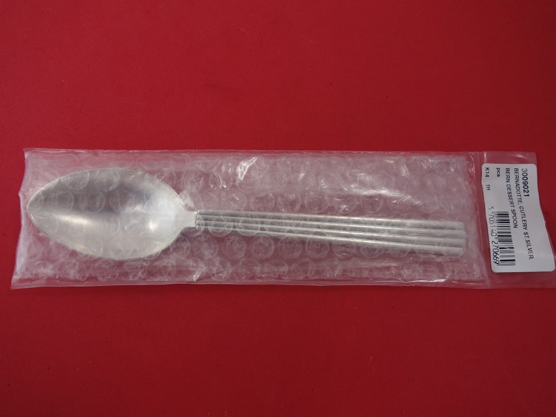 Georg Jensen Bernadotte Sterling Silver Dessert Spoon 7 3/8" New: Georg Jensen Bernadotte Sterling Silver Dessert Spoon 7 3/8" New Indulge in elegance with the Bernadotte dessert spoon by Georg Jensen, a timeless piece crafted from high-quality sterling silver. This